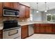 Well-equipped kitchen offers stainless steel appliances, wood cabinetry, and convenient breakfast bar at 10876 Eclipse Lily Way # 60, Orlando, FL 32832