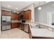 Traditional kitchen features stainless steel appliances, wood cabinetry, and tile backsplash at 10876 Eclipse Lily Way # 60, Orlando, FL 32832