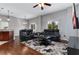 Spacious living room boasts hardwood floors, a ceiling fan, recessed lighting, and neutral paint at 10876 Eclipse Lily Way # 60, Orlando, FL 32832