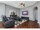 The cozy living room features hardwood floors, a ceiling fan, and a large window for natural light at 10876 Eclipse Lily Way # 60, Orlando, FL 32832