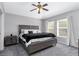 Spacious main bedroom featuring two windows for natural light, a ceiling fan, and soft carpeting at 10876 Eclipse Lily Way # 60, Orlando, FL 32832