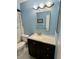Bathroom features blue walls and a vanity with a white countertop at 1130 W Minnehaha Ave, Clermont, FL 34711