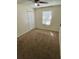 This bedroom has neutral carpet, white walls and a ceiling fan at 1130 W Minnehaha Ave, Clermont, FL 34711