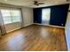 Large bedroom with two windows that provide plenty of natural light and laminate wood flooring at 1130 W Minnehaha Ave, Clermont, FL 34711