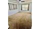 This bedroom has neutral carpet, white walls and a ceiling fan at 1130 W Minnehaha Ave, Clermont, FL 34711