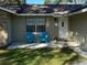 Inviting front porch featuring a pair of blue chairs and a well-maintained lawn at 1130 W Minnehaha Ave, Clermont, FL 34711