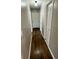 Hallway features wood-look flooring and white doors at 1130 W Minnehaha Ave, Clermont, FL 34711
