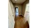 Hallway features wood-look flooring and white doors at 1130 W Minnehaha Ave, Clermont, FL 34711