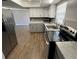 Well-equipped kitchen with stainless steel appliances, updated cabinets, and solid surface countertops at 1130 W Minnehaha Ave, Clermont, FL 34711
