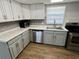 Well-equipped kitchen with stainless steel appliances, updated cabinets, and solid surface countertops at 1130 W Minnehaha Ave, Clermont, FL 34711