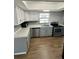 Well-equipped kitchen with stainless steel appliances, updated cabinets, and solid surface countertops at 1130 W Minnehaha Ave, Clermont, FL 34711