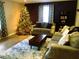 Cozy living room with comfortable seating, laminate wood flooring, and a beautiful Christmas tree at 1130 W Minnehaha Ave, Clermont, FL 34711