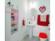 Stylish bathroom with decorative vanity, sink, tile floor and red themed decorations at 1284 Spotted Sandpiper Loop, Winter Springs, FL 32708