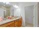 Bathroom with double sink granite vanity, large mirror and walk-in shower at 1284 Spotted Sandpiper Loop, Winter Springs, FL 32708