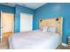 Bedroom featuring a bed with a decorative headboard, a closet, and an open doorway at 1284 Spotted Sandpiper Loop, Winter Springs, FL 32708