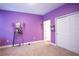 Cozy bedroom featuring purple walls, closet, and carpet at 1284 Spotted Sandpiper Loop, Winter Springs, FL 32708