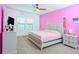 Brightly painted primary bedroom with a ceiling fan and large windows at 1284 Spotted Sandpiper Loop, Winter Springs, FL 32708
