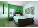 Cozy bedroom with bright green accent wall, decorative vine accents and natural light at 1284 Spotted Sandpiper Loop, Winter Springs, FL 32708