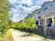 Townhome exterior with lush landscaping and walking path at 1284 Spotted Sandpiper Loop, Winter Springs, FL 32708
