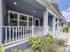 Relaxing front porch with comfortable seating and classic white railings at 1284 Spotted Sandpiper Loop, Winter Springs, FL 32708