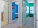 Hallway featuring an open doorway with carpeted flooring leading into bedrooms with colorful accent walls at 1284 Spotted Sandpiper Loop, Winter Springs, FL 32708