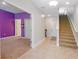 Inviting hallway with tile floors, staircase and an open doorway to a bedroom at 1284 Spotted Sandpiper Loop, Winter Springs, FL 32708