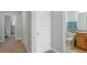 Hallway featuring neutral walls, white doors, and access to a well-lit bathroom at 1284 Spotted Sandpiper Loop, Winter Springs, FL 32708