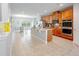 Open-concept kitchen features an oversized island, granite countertops, tile floors, and stainless steel appliances at 1284 Spotted Sandpiper Loop, Winter Springs, FL 32708
