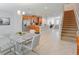 Bright kitchen features stainless appliances, center island, and tile floors, seamlessly connects to dining and living areas at 1284 Spotted Sandpiper Loop, Winter Springs, FL 32708