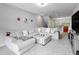 Bright, open-concept living room with plush sectional and modern decor at 1284 Spotted Sandpiper Loop, Winter Springs, FL 32708