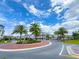 Well-manicured street with palm trees in a roundabout of a cozy community at 1284 Spotted Sandpiper Loop, Winter Springs, FL 32708