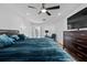 Relaxing bedroom with wood floors, a large bed, ceiling fan, and a view into the ensuite bathroom at 13201 Lakewind Dr, Clermont, FL 34711