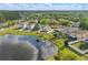 Aerial view of homes nestled around a beautiful pond, showcasing a tranquil and desirable neighborhood setting at 13212 Briar Forest Ct, Orlando, FL 32828