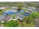 Aerial view of homes surrounding a picturesque pond, providing a serene and community-rich environment at 13212 Briar Forest Ct, Orlando, FL 32828