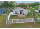 Aerial view of a well-kept, fenced backyard with a small patio, perfect for relaxation and outdoor enjoyment at 13212 Briar Forest Ct, Orlando, FL 32828