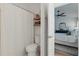 Bright bathroom with stylish white fixtures, decorative shelving, and an open doorway to the bedroom at 13212 Briar Forest Ct, Orlando, FL 32828
