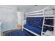 bedroom featuring bunk beds with star patterned cover and access to the bathroom at 13212 Briar Forest Ct, Orlando, FL 32828