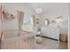 Charming Bedroom features a crib, elegant chandelier, and a dresser with decorative accents at 13212 Briar Forest Ct, Orlando, FL 32828