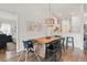 Dining area with a large wooden table, modern light fixture, and wood flooring at 13212 Briar Forest Ct, Orlando, FL 32828