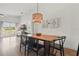 Bright dining area features a stylish light fixture, and views of the outdoor area at 13212 Briar Forest Ct, Orlando, FL 32828