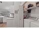 Convenient laundry area with washer, dryer, storage shelves, and organized space, adjacent to the kitchen at 13212 Briar Forest Ct, Orlando, FL 32828