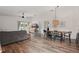 Well-lit living area with a gray sofa, hardwood floors, and backyard access through a sliding glass door at 13212 Briar Forest Ct, Orlando, FL 32828