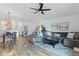 Open-concept living area with hardwood floors, modern decor, and comfortable seating at 13212 Briar Forest Ct, Orlando, FL 32828