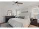 Bright main bedroom featuring neutral decor, a ceiling fan, and large windows at 13212 Briar Forest Ct, Orlando, FL 32828