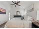 Cozy main bedroom with a ceiling fan, hardwood floors, and natural light at 13212 Briar Forest Ct, Orlando, FL 32828
