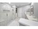 Bright bathroom featuring a glass shower, double sinks, and neutral tiling at 13224 Casper Ln, Clermont, FL 34711