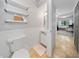 Compact bathroom with modern fixtures and shelving at 13224 Casper Ln, Clermont, FL 34711