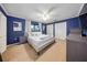 Bright bedroom with blue walls, white trim, neutral carpet, and plenty of closet space at 13224 Casper Ln, Clermont, FL 34711