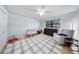 Light-filled bedroom featuring a crib, dresser, and comfortable armchair at 13224 Casper Ln, Clermont, FL 34711