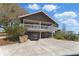View of home featuring elevated deck, car garage, and front driveway at 13224 Casper Ln, Clermont, FL 34711